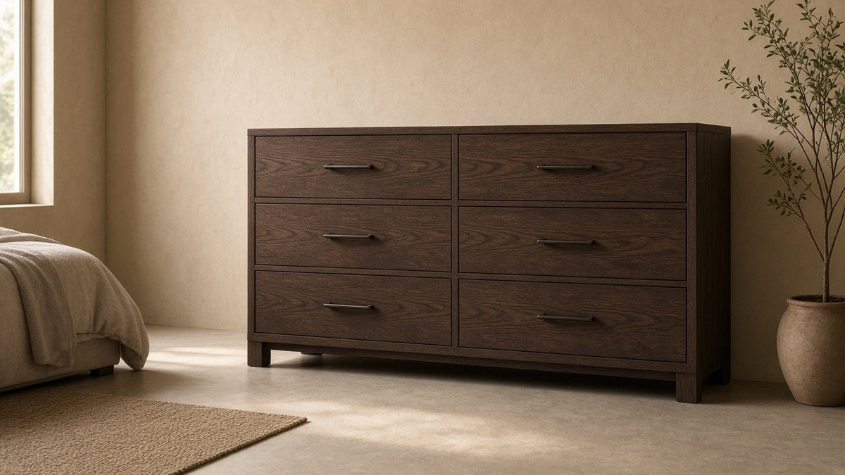 Winslow six-drawer dresser smokey walnut in empty bedroom, warm plaster walls, soft daylight