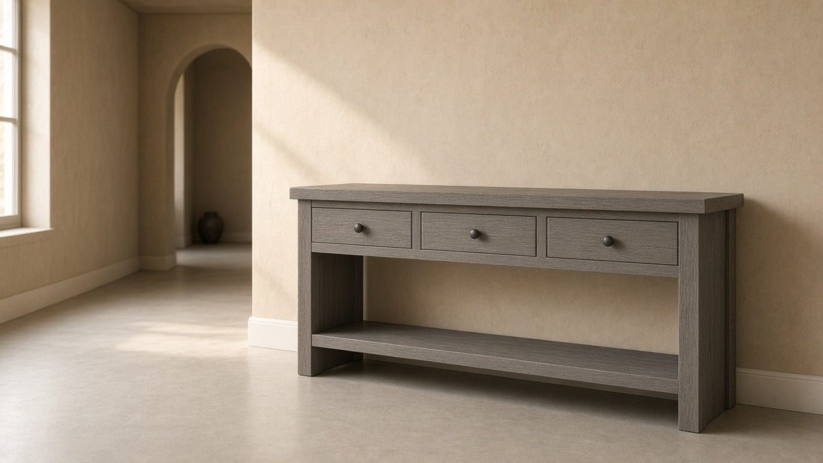 Sparrow solid wood gray console table in empty entry hall, warm plaster walls, soft daylight