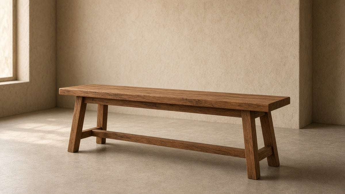 Solid sheesham wood bench in empty hall, warm plaster walls, soft daylight