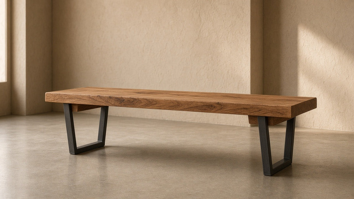 Solid sheesham bench with metal legs in empty hall, warm plaster walls, soft daylight