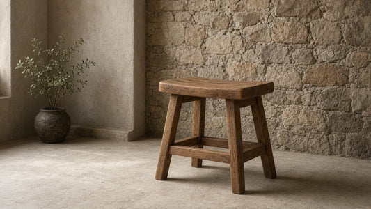 Naive solid wood stool in a quiet plaster and stone room