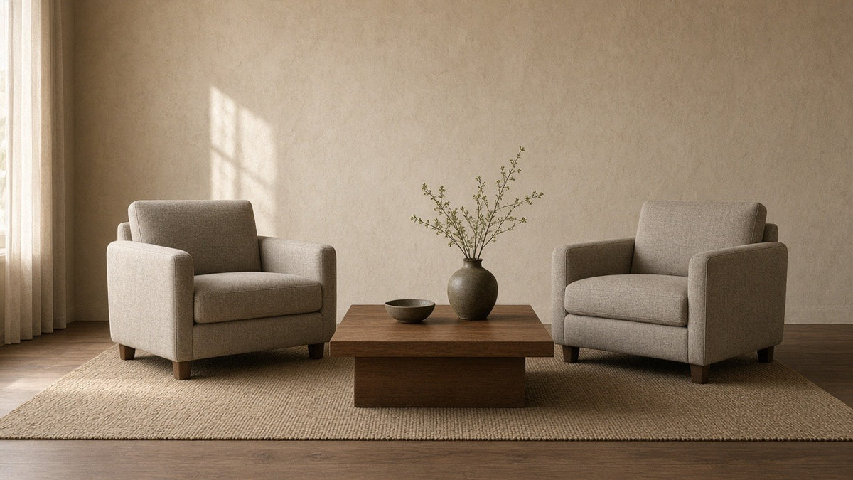Caydon two club chairs and table in empty living room, warm plaster walls, soft daylight