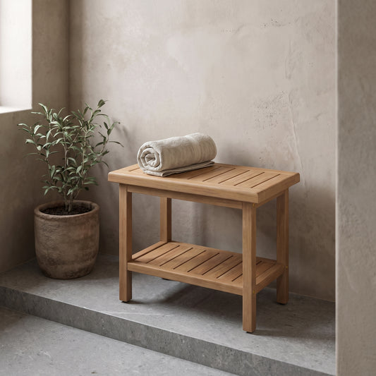 21'' Teak Shower Bench with storage shelf, natural teak wood, placed on a concrete walkway with a potted plant nearby.
