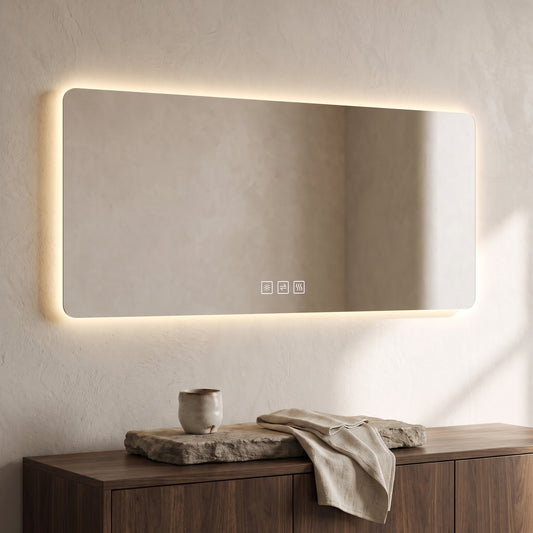 Rectangular LED bathroom mirror with frame, demist function buttons, and warm light on the top