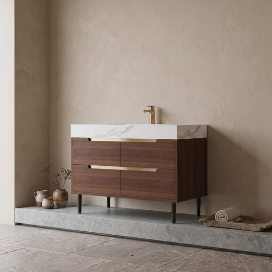 35.4" Farmhouse Free-standing Sintered Stone Bathroom Vanity with walnut cabinet and brass handles, white stone countertop, brass faucet, minimalist room with neutral tones and decorative items.