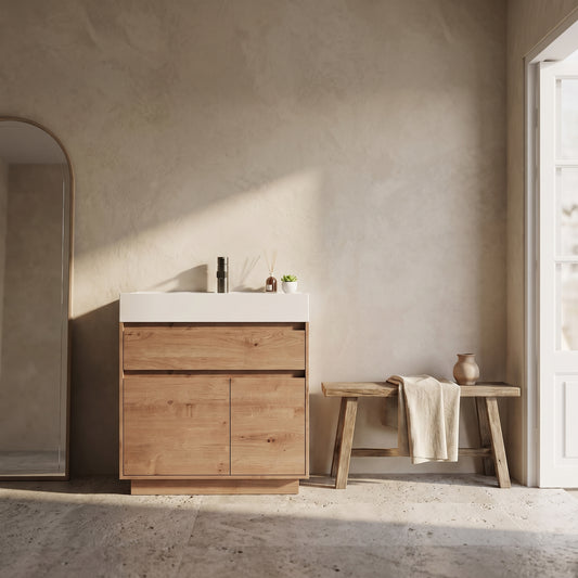 A minimalist 60 Inch wall-mounted bathroom vanity with resin sink and oak finish in a serene bathroom setting.