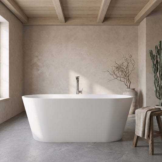 A 71-inch white freestanding bathtub with a modern faucet in a minimalist bathroom with concrete floors, wooden beams, and natural decor