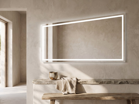 Modern rectangular LED mirror light above a stone ledge with rustic wooden bench in minimalist bathroom setting.