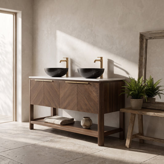 Wooden vanity with marble top and black sinks, situated in a minimalist bathroom with natural light and decorative plants.