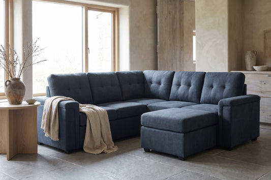 Blue textured sectional sofa and ottoman in a minimalist room setting, light wooden furniture, potted plant decoration.