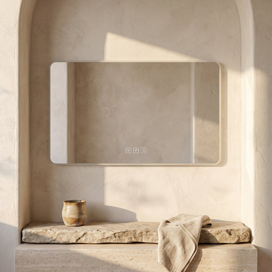 LARGE BATHROOM MIRROR WITH DIMMABLE BACKLIGHT, WHITE FRAME, BEIGE WALL, STONE SHELF WITH TOWEL AND BROWN VASE, SUBTLE SHADES.