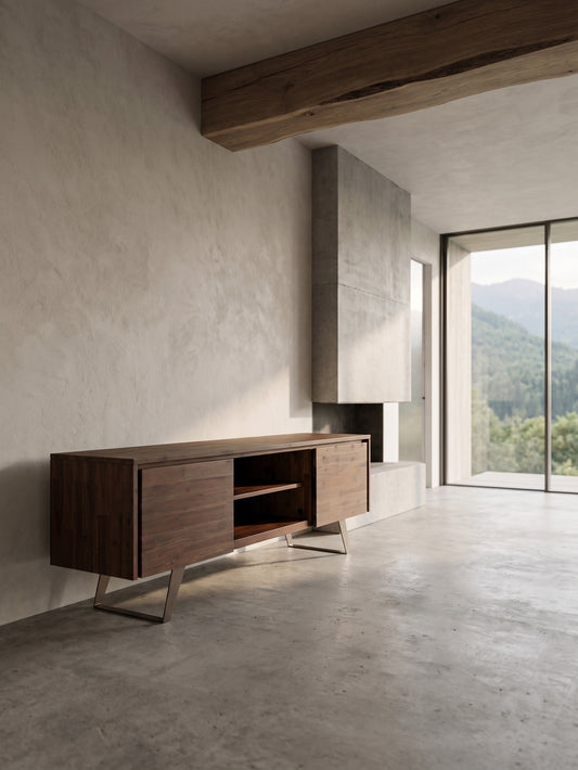 Lowry 63 Inch Wide Solid Walnut TV Stand with metal legs, set against a concrete floor and wall with wooden beams.