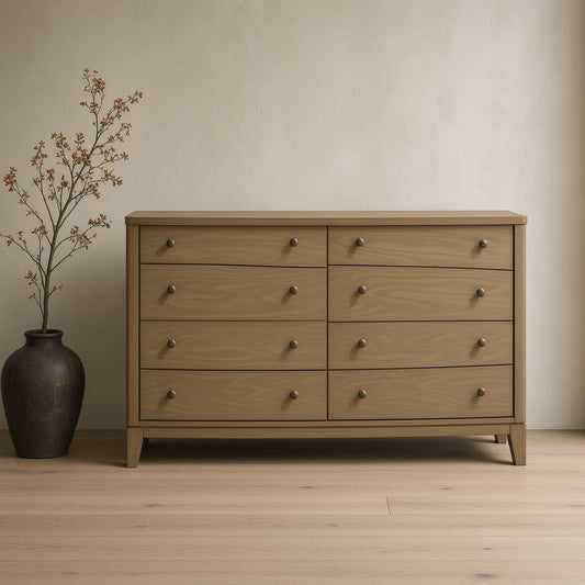 Wooden eight-drawer dresser cabinet in natural finish, dark vase with leafy plant on wooden floor against textured wall