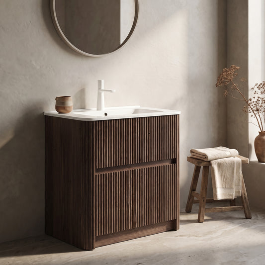 Noor 24" Bathroom Vanity with Sink, wooden frame, beige wall, circular mirror, stool with folded towels