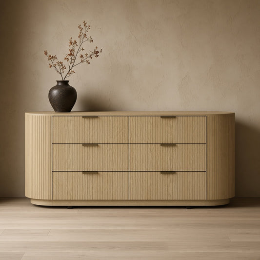 Modern double dresser with 6 drawers, light wood finish, beige walls, brown vase on top, hard wood floor