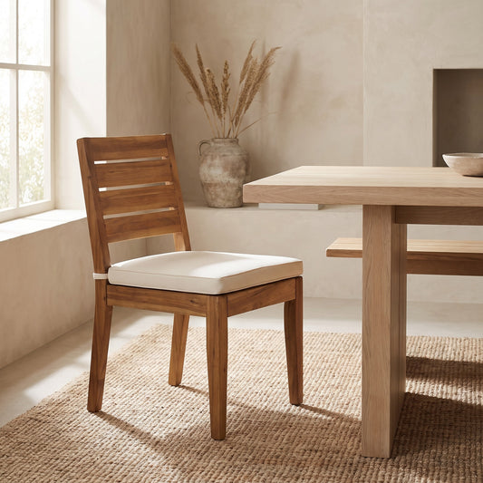 A wooden dining chair with a cushion in a light beige setting