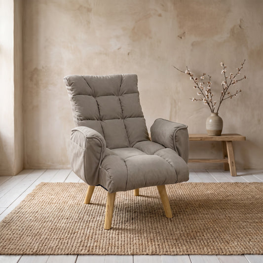 Taupe colored recliner on woven rug, wooden legs, beige textured wall, minimalistic vase on small wooden table, natural lighting