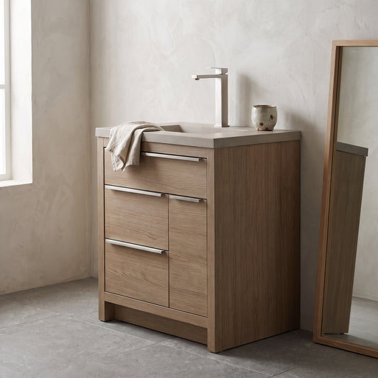 Bathroom sink with brushed nickel faucet and light wood vanity.