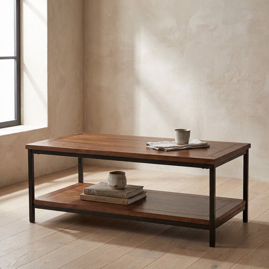 Dark wood coffee table with a lighter lower shelf holding books and a mug in an empty room with natural light coming from a window.