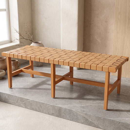 Rectangular wooden bench with woven leather seat in light brown interior with decorative vases