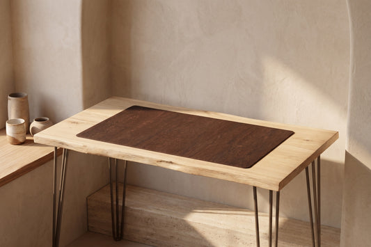 Small rectangular brown desk mat on a wooden desk with hairpin legs in a minimalistic setting