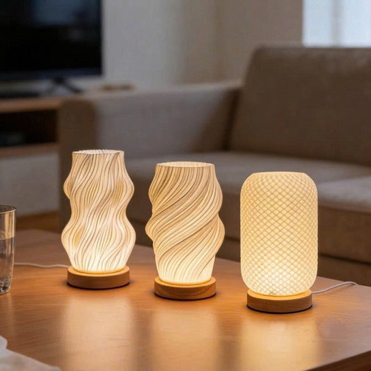 Three LED textured table lamps with wooden bases arranged on a table, emitting warm light.